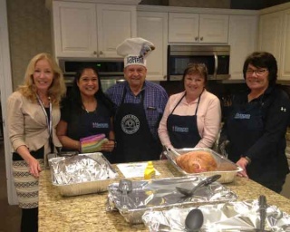 Hanscom FCU volunteers preparing a meal in kitchen