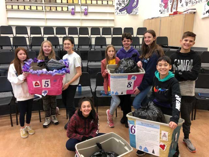 Middle schoolers pose with donations they gathered for the Giving Tree Project
