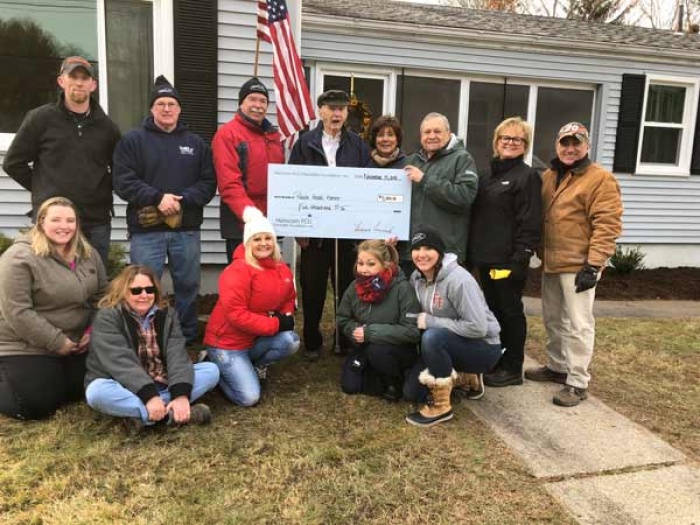 Volunteers from Hanscom Federal Credit Union Home Depot in Waltham MA and Purple Heart Homes with US Air Force Veteran Wayne Orpin