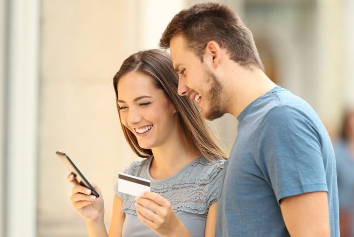 couple shopping on mobile phone with credit card