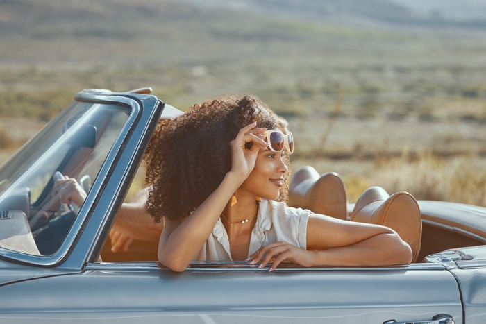 woman passenger in convertible looking back